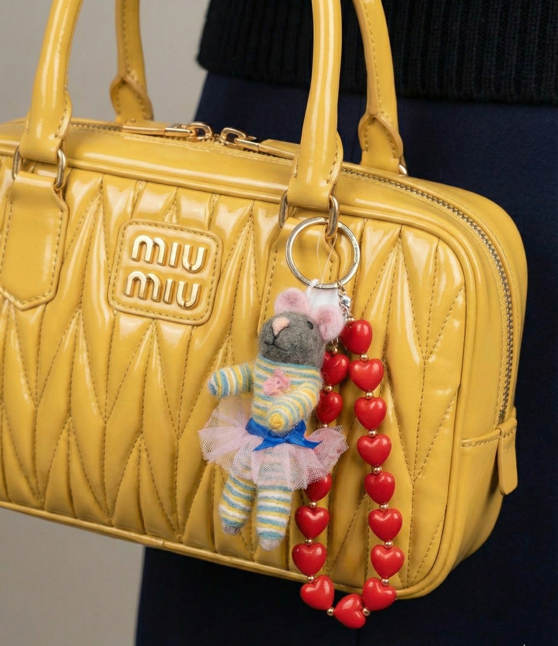 Yellow Miu Miu bag styled with striped ballerina mouse keychain and heart bead strap for Y2K aesthetic