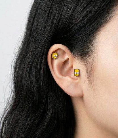 Simpsons family piercings layered on ear - Marge, Bart, and Lisa studs on helix, conch, and lobe piercings