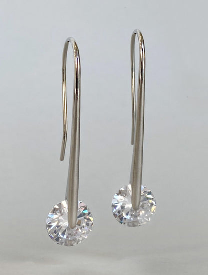  Pair of silver plated 43mm long drop earrings with sparkling 10mm cubic zirconia on white background