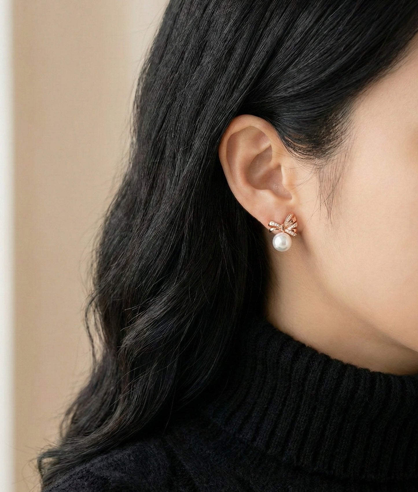 Silver bow pearl stud earrings worn outdoors in natural light, Balletcore aesthetic