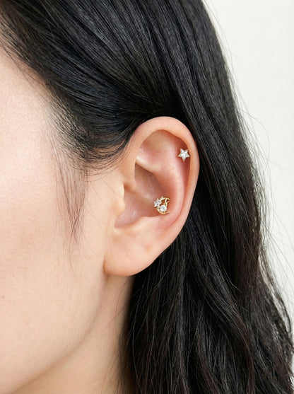 Gold plated crescent moon rabbit piercing in conch with star stud in helix for celestial ear curation