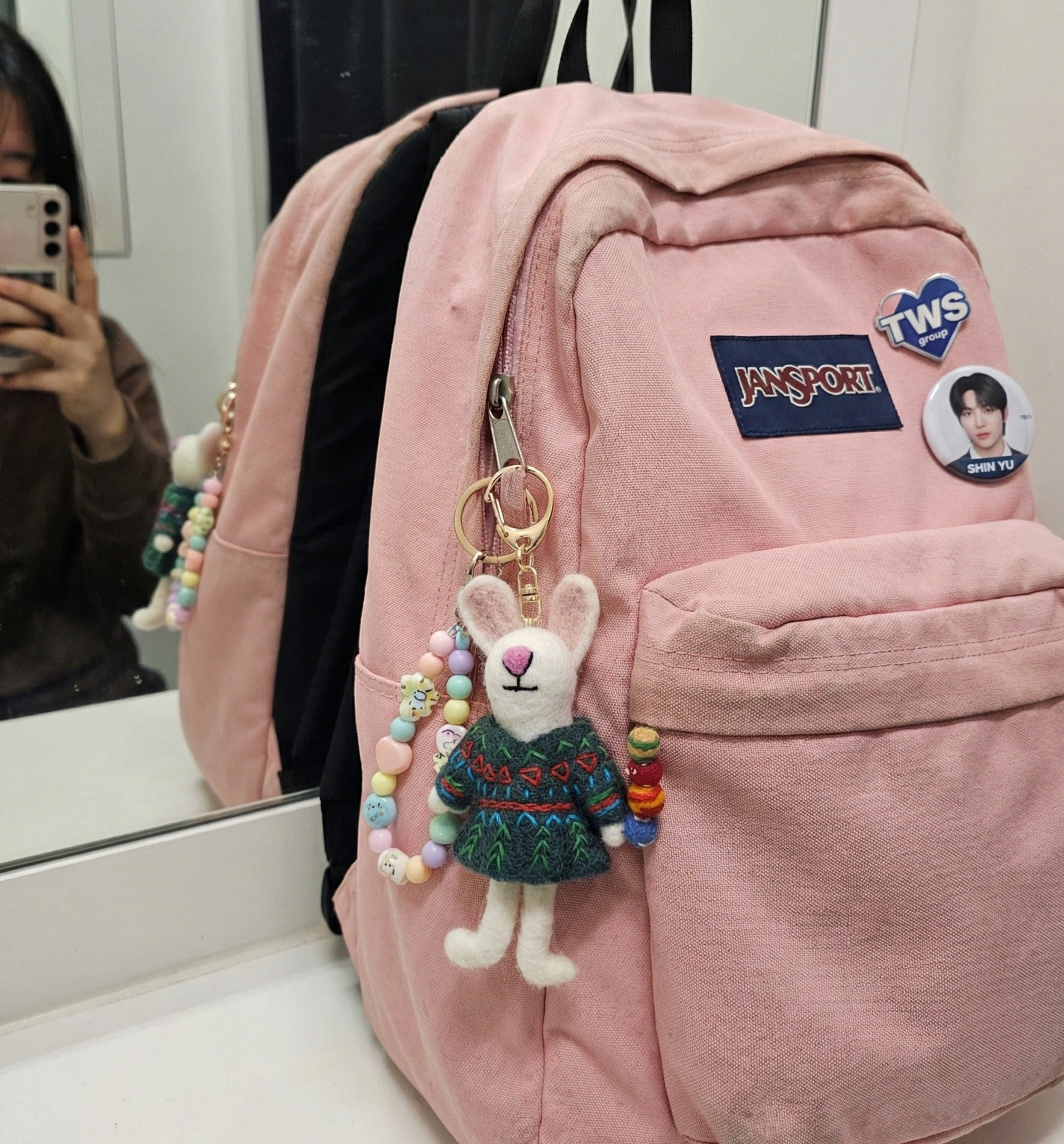 Pink Jansport backpack decorated with handmade rabbit felt keychain and colorful beaded charm