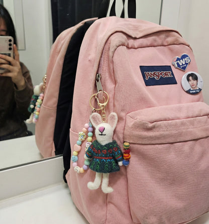 Pink Jansport backpack decorated with handmade rabbit felt keychain and colorful beaded charm