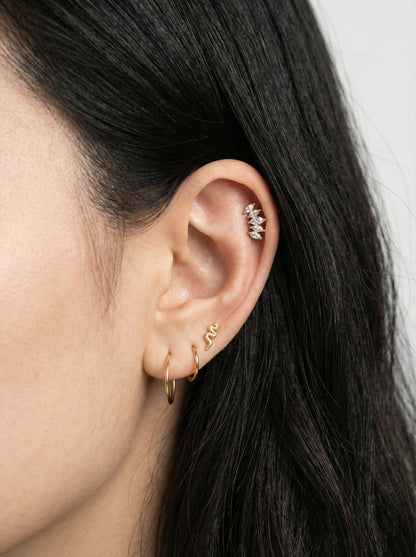Elegant ear stack featuring wing marquise piercing on cartilage with gold hoops