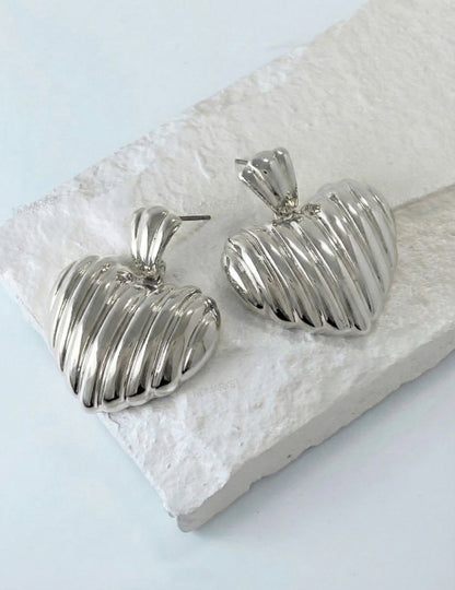 Silver chunky heart earrings with vertical pleated texture close-up