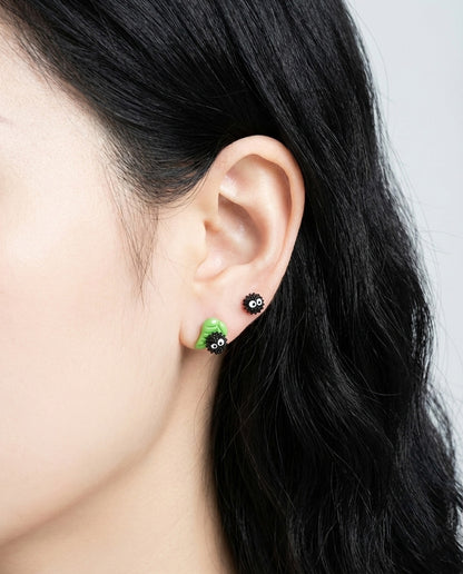 Side profile of model wearing green leaf Soot Sprite earrings in layered double piercing style