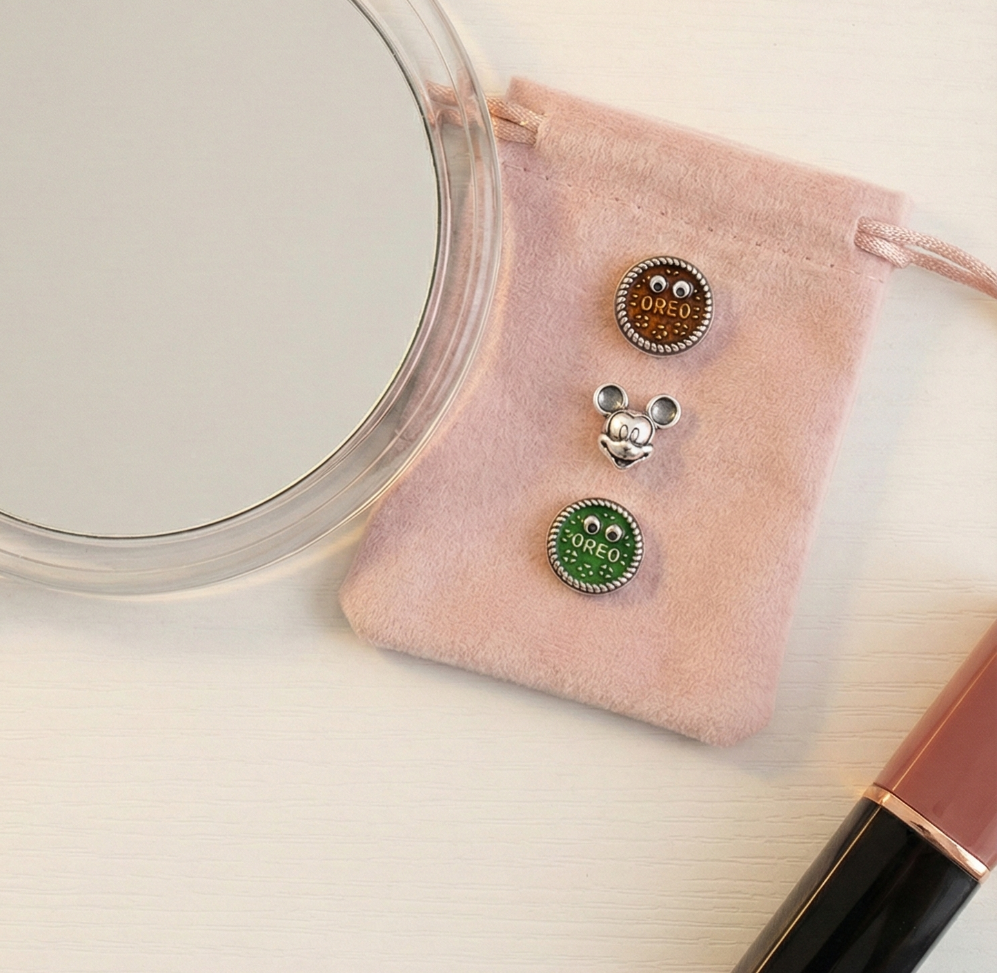 Lifestyle shot of three piercings on open book page with cosmetic items
