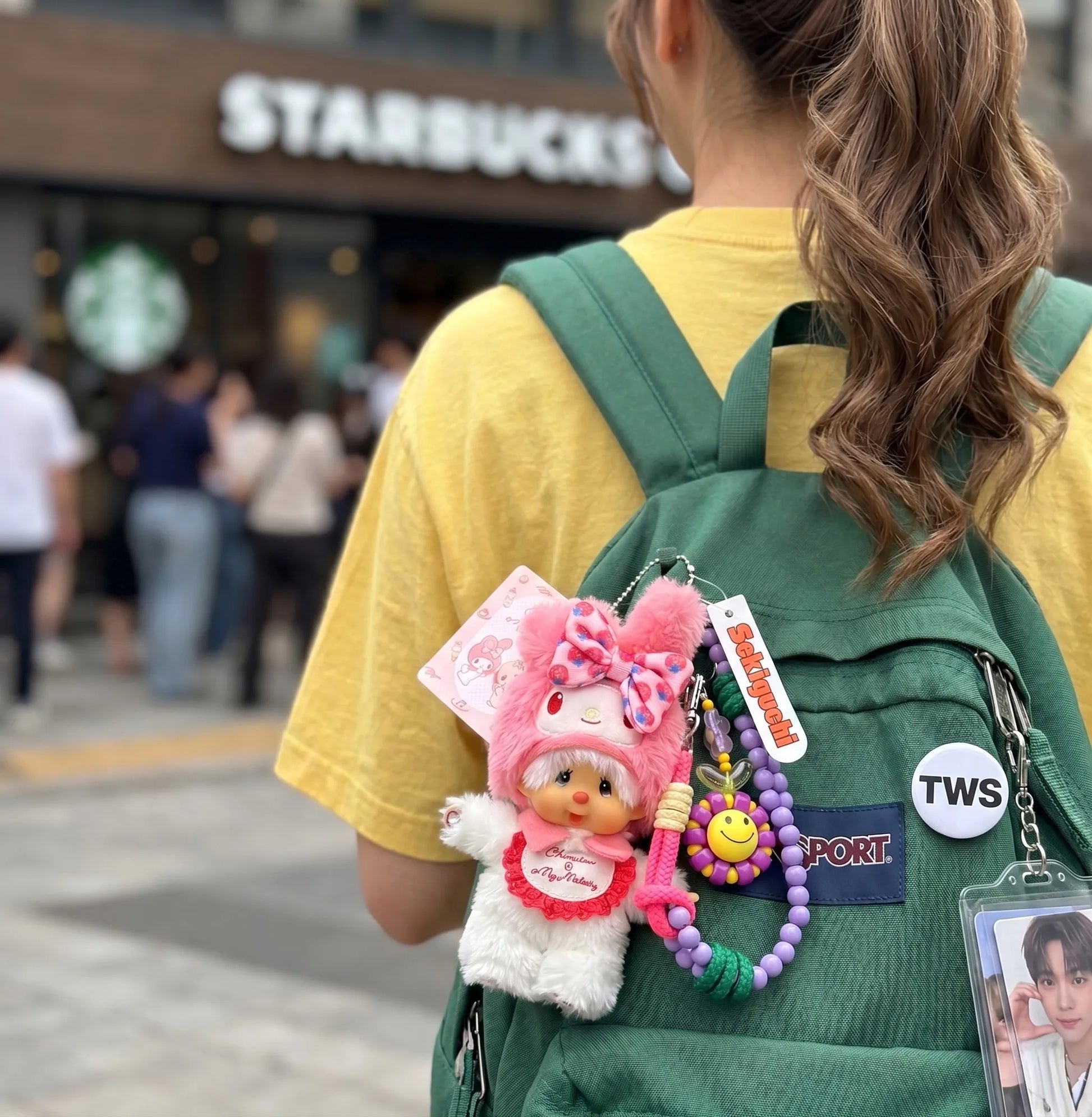 Kawaii plush character bag charm on green JanSport backpack with smile bead strap — K-fashion streetwear bag layering look by 8ttitto8