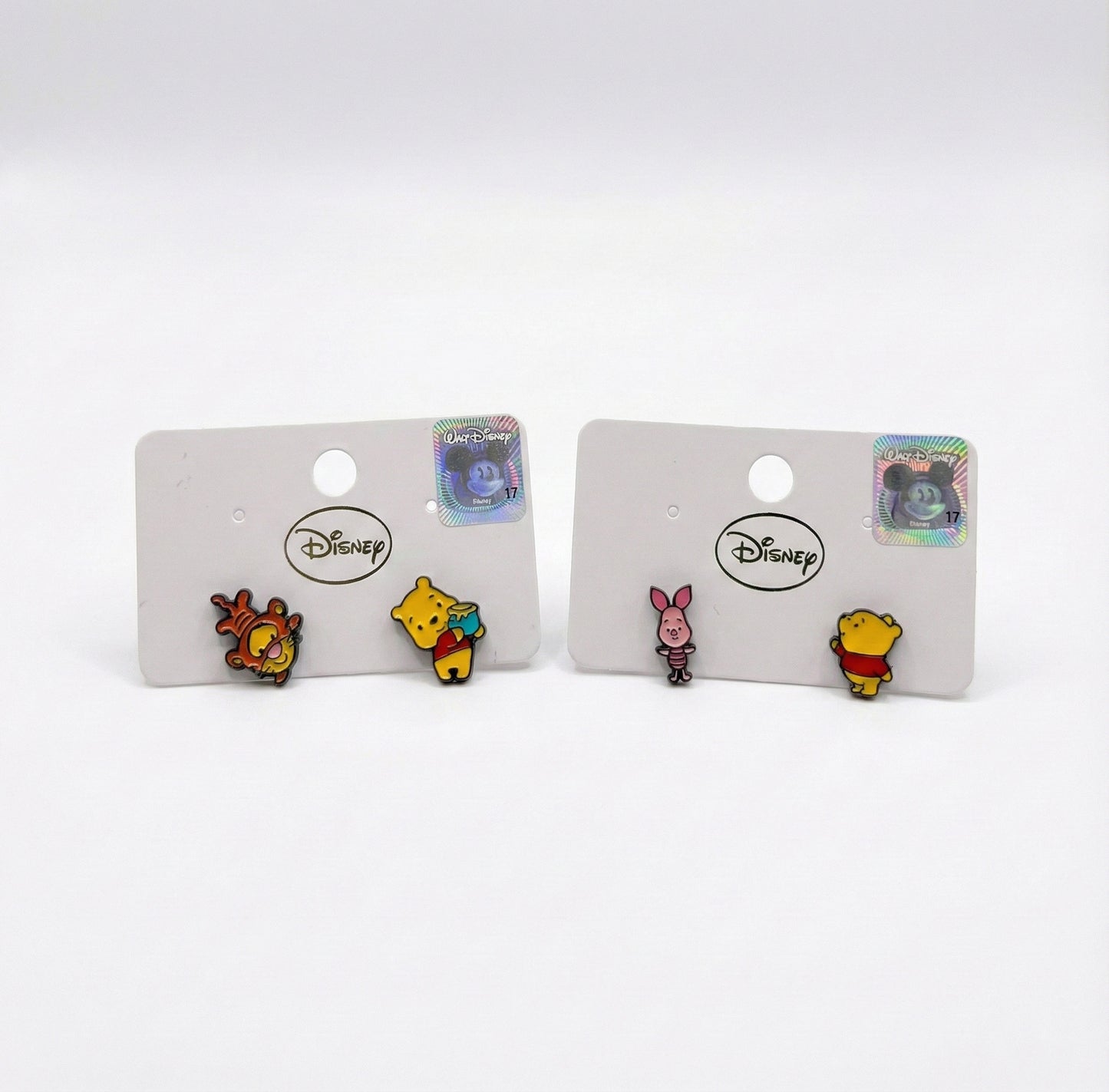 Two sets of Disney Pooh earrings side by side: Tigger with Pooh and Piglet with Pooh, mismatched design comparison