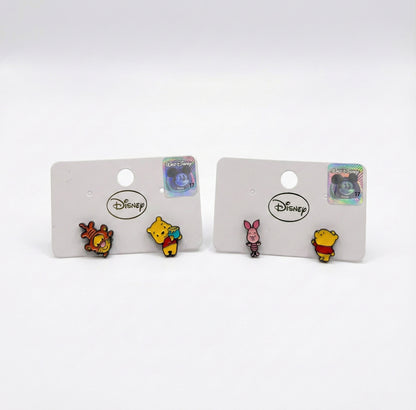 Two sets of Disney Pooh earrings side by side: Tigger with Pooh and Piglet with Pooh, mismatched design comparison