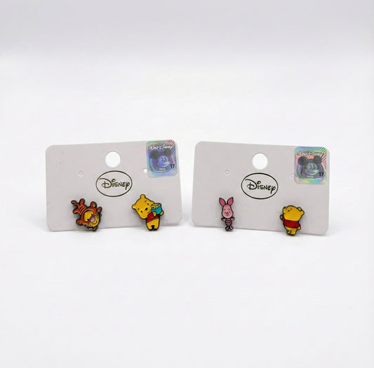 Two sets of Disney Pooh earrings side by side: Tigger with Pooh and Piglet with Pooh, mismatched design comparison