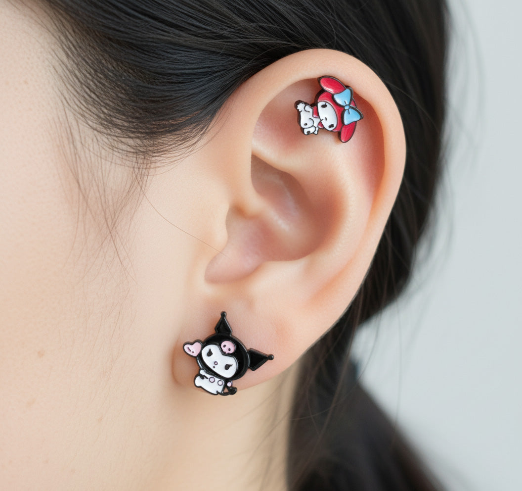 My Melody and Kuromi mix earrings on ear showing cartilage helix and earlobe styling