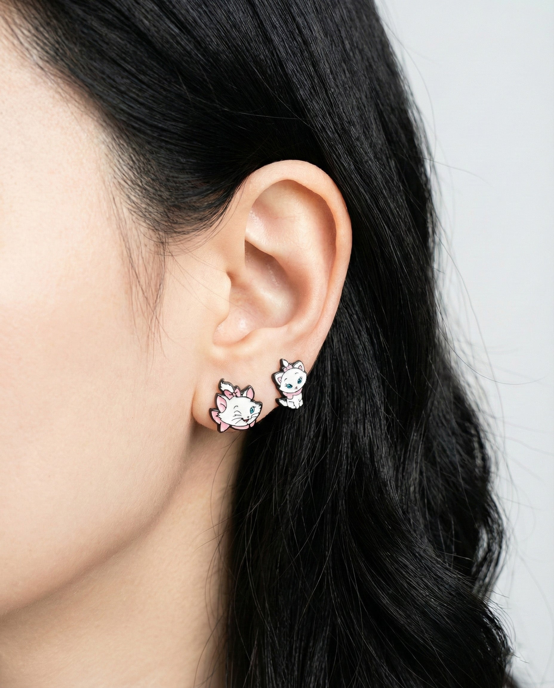 Model showcasing Marie cat earrings with both winking and sitting designs