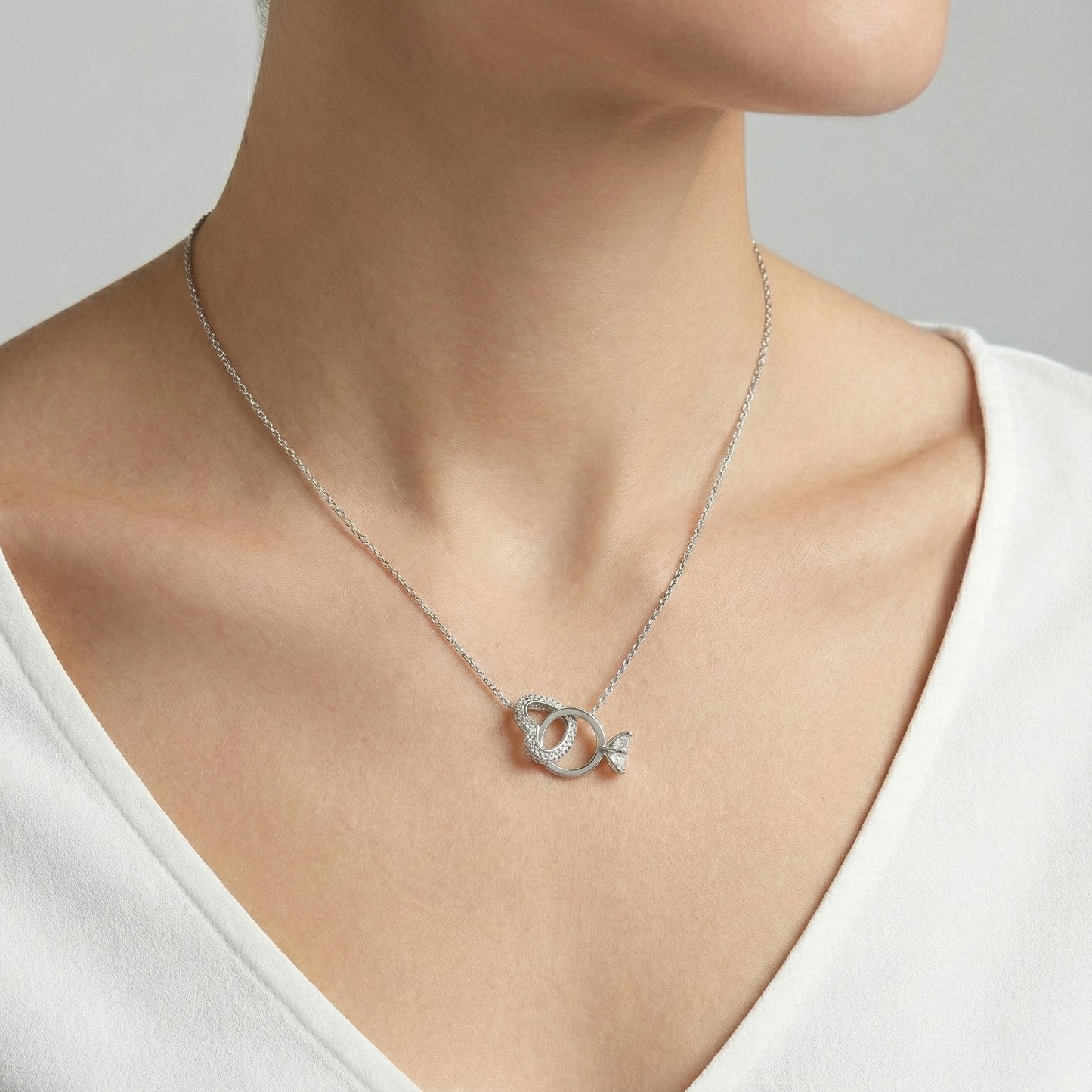 Sterling silver plated heart pendant necklace worn by woman