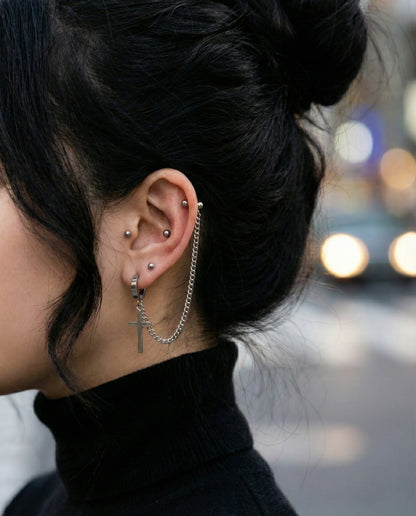 Gothic style ear curation with connected lobe and cartilage chain piercing  