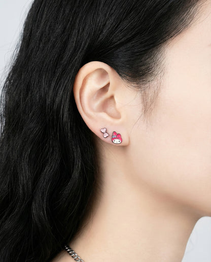 My Melody character earrings with pink ribbon and cupcake studs worn as layered piercings