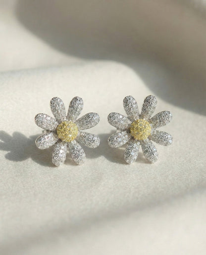 Two daisy flower earrings with yellow center cubic zirconia - front view detail shot