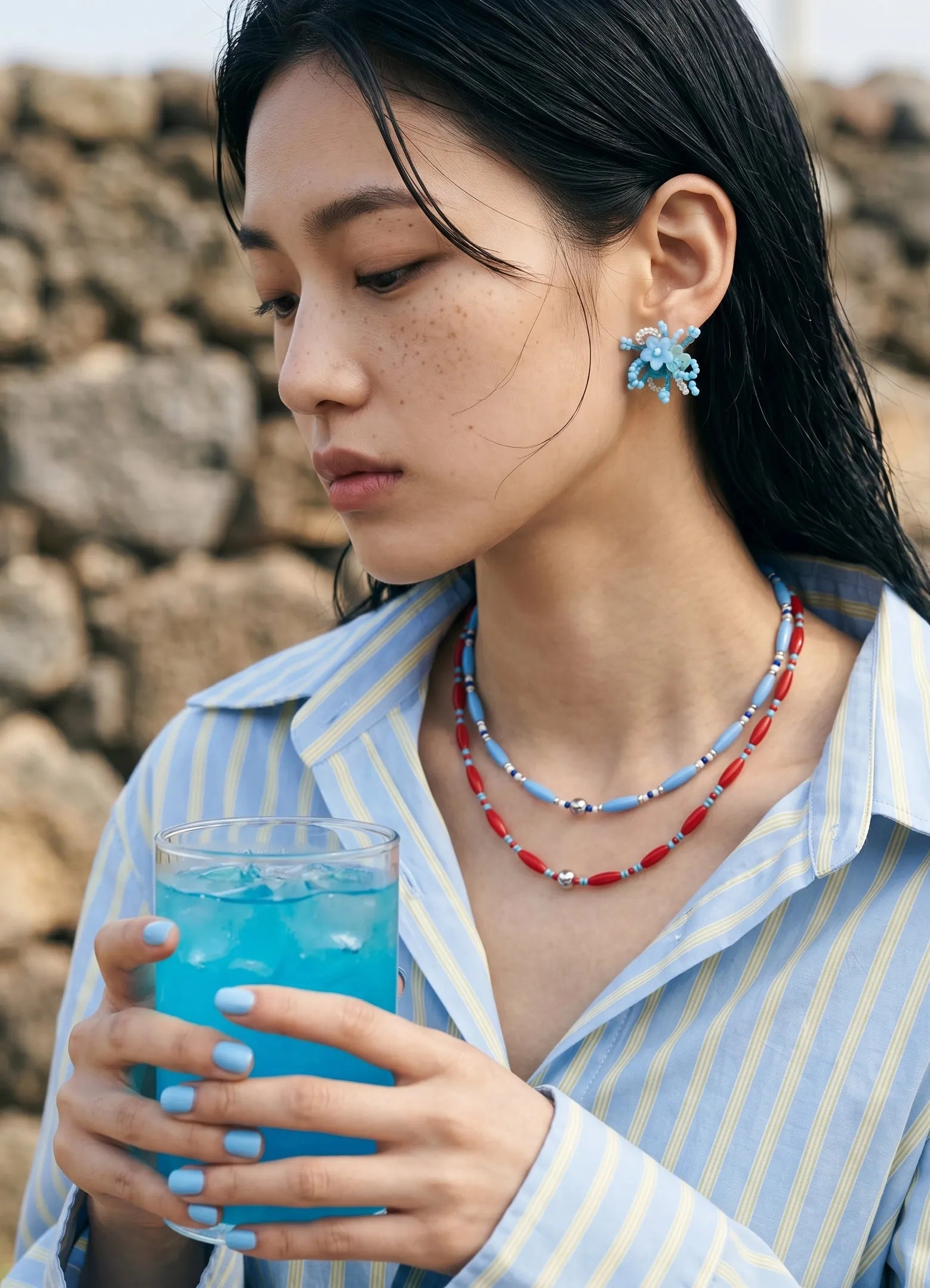 K-style vacation outfit blue and red beaded necklace stack, striped shirt styling