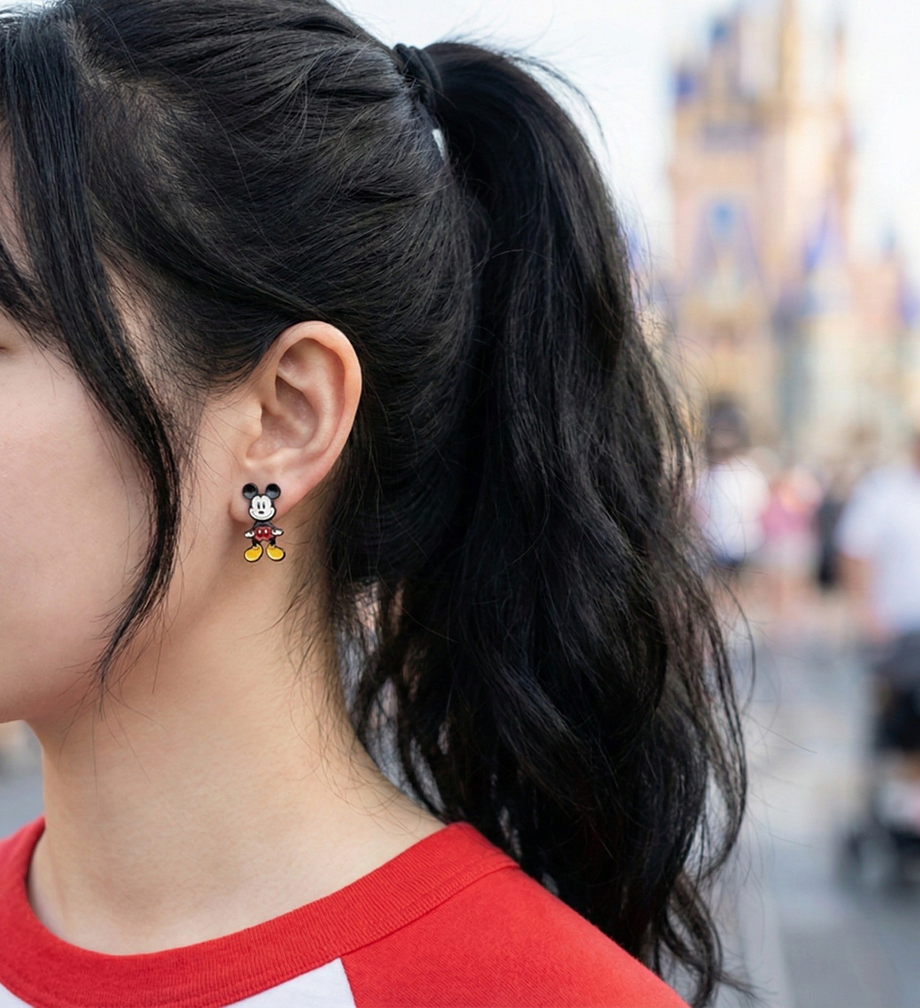 Mickey Mouse front-back 3D earring worn on ear showing handmade enamel detail and sterling silver post