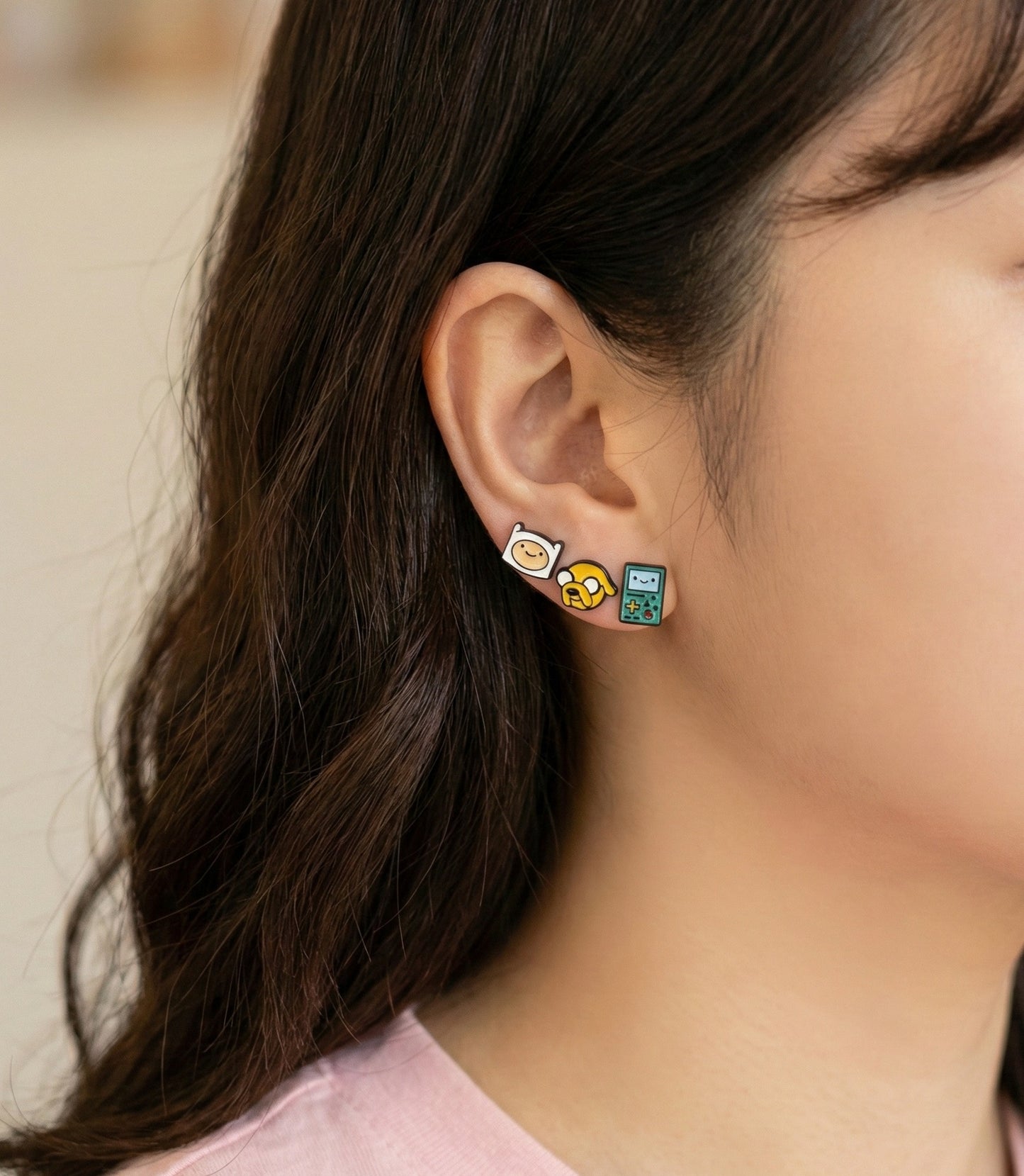  Model wearing Adventure Time character earrings Finn Jake BMO layered on earlobe, Korean jewelry styling 