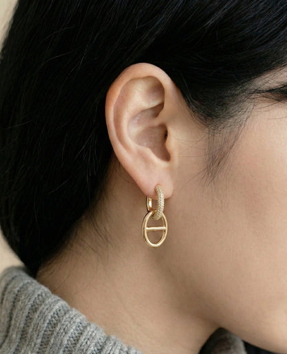Side view of elegant anchor chain drop earrings on model ear