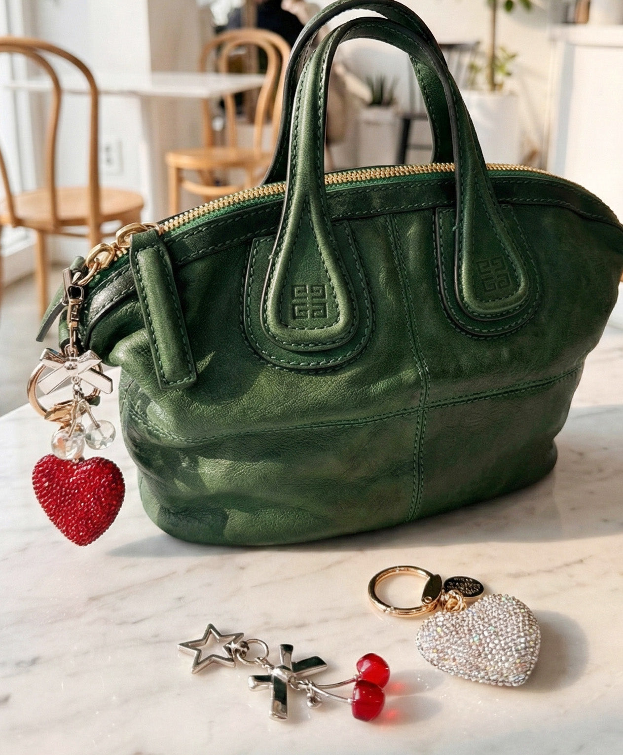 Green leather handbag with heart charm accessories and star pendants