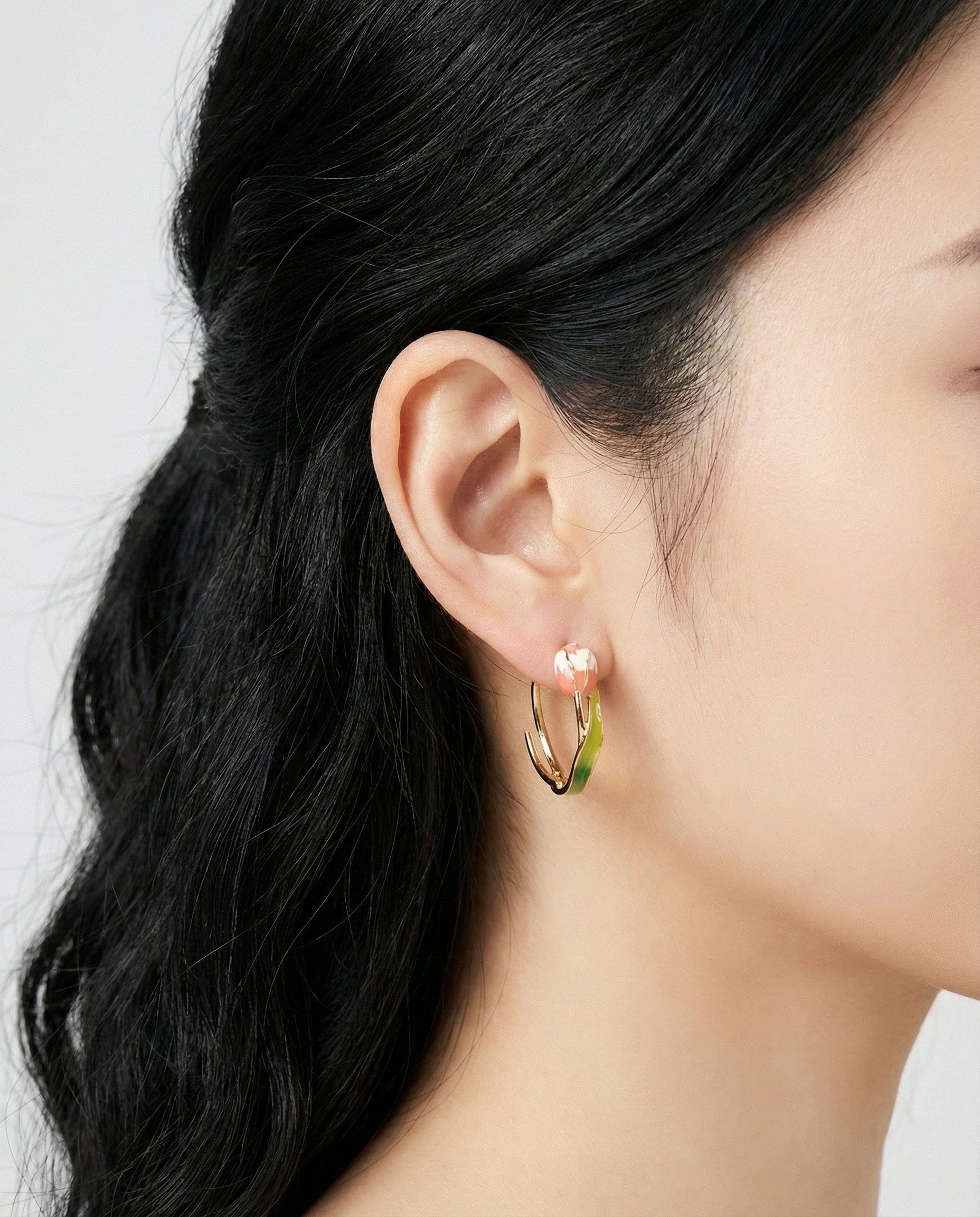 Side view of handmade tulip hoop earring showing dimensional petal detail