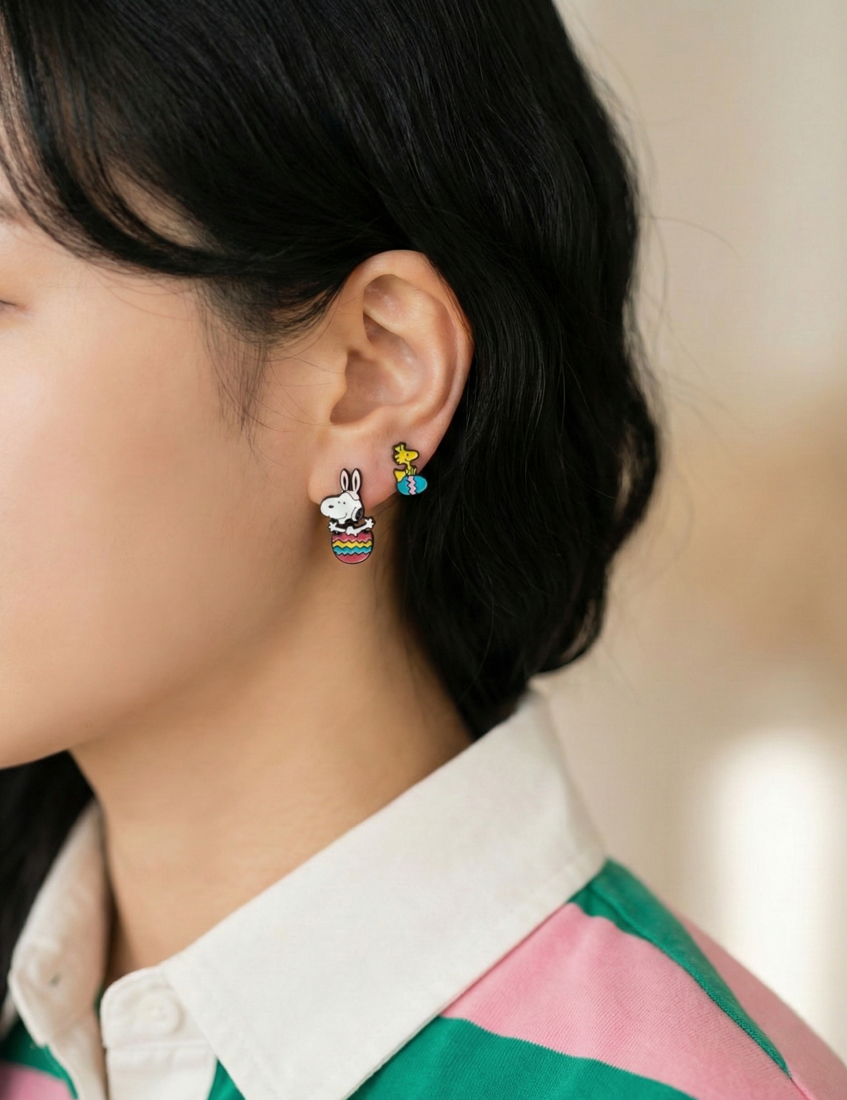 Two-way ear jacket components separated showing Snoopy head and Easter egg body pieces