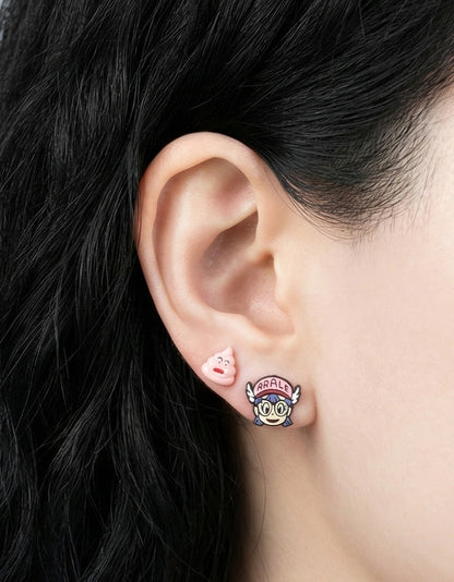 Woman wearing asymmetrical Arale anime earrings showing mismatched character design, black hair and casual style