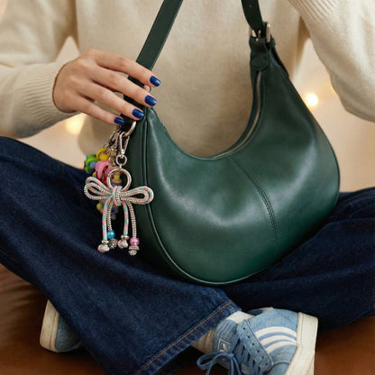 Green hobo bag with pink multicolor rhinestone bow charm and floral bead details