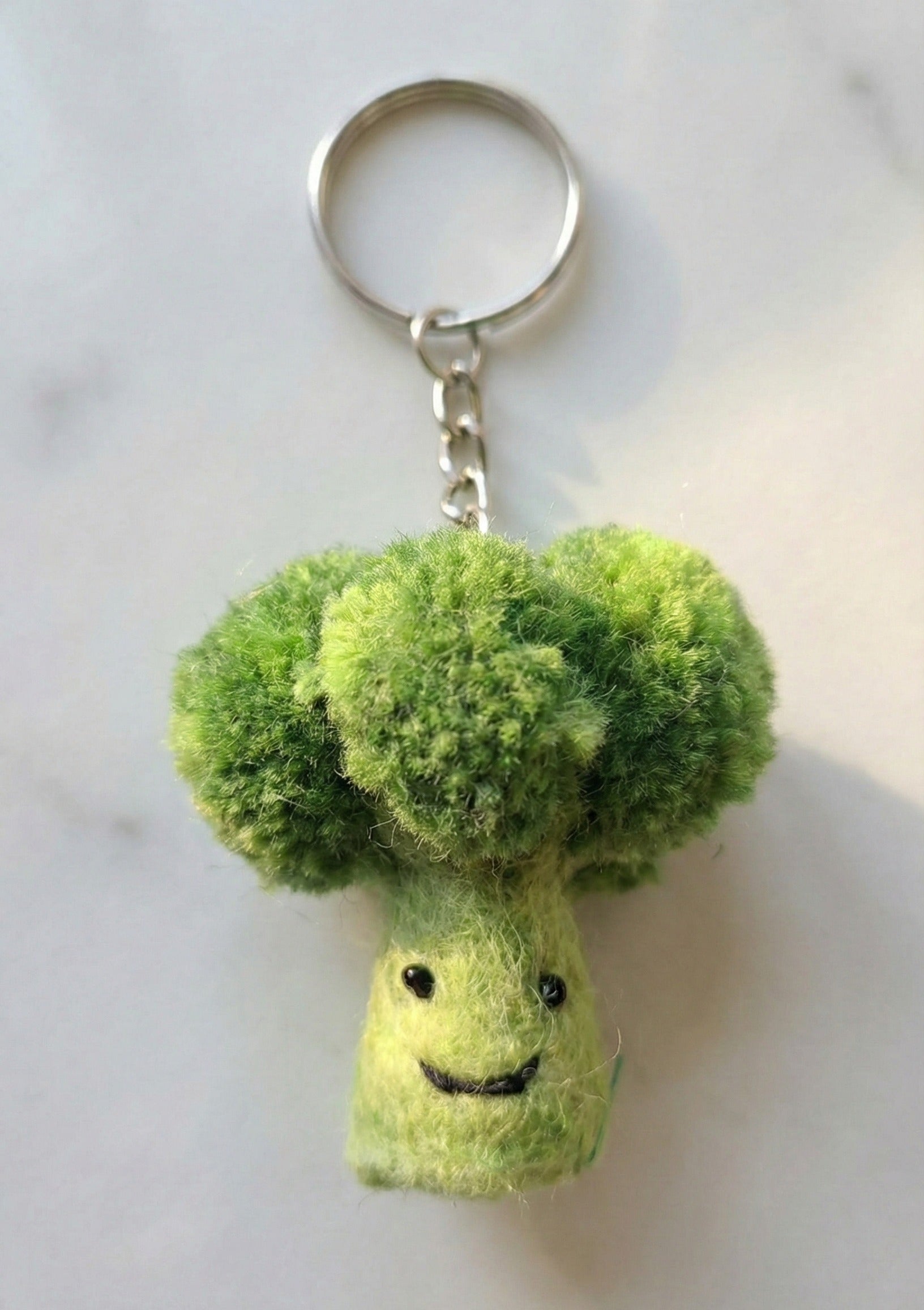 Fluffy broccoli wool felt keychain with voluminous green top and happy face"