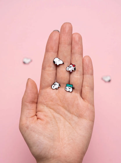 Vintage cartoon stud earrings in palm, hypoallergenic stainless steel jewelry closeup