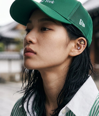 Monchhichi enamel stud styled in ear stack with mixed piercings — street-cute K-style look, handmade in Korea
