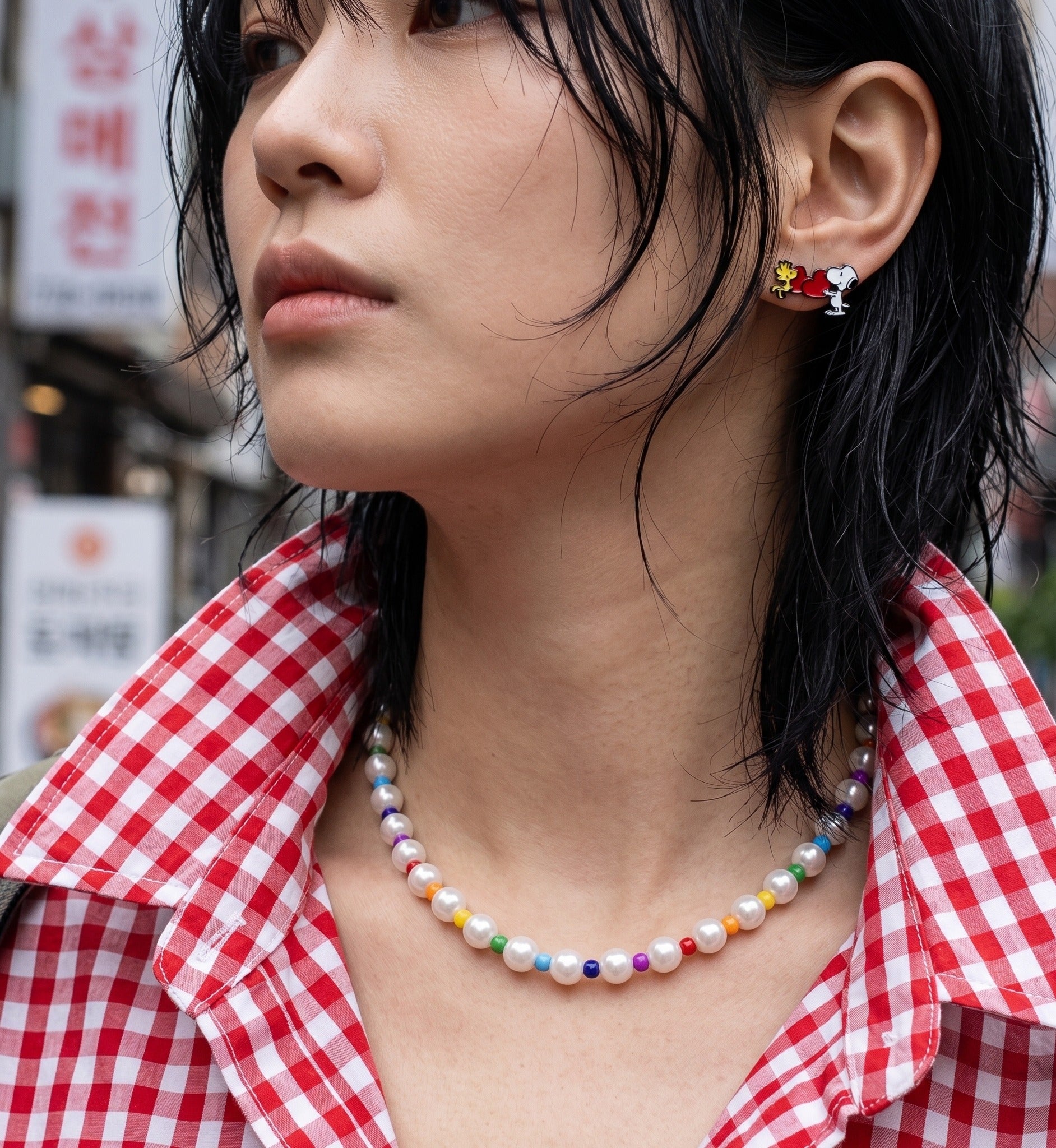 Kidcore aesthetic ear stack inspo with Snoopy studs, Y2K layered rainbow bead pearl necklace for daily wear.