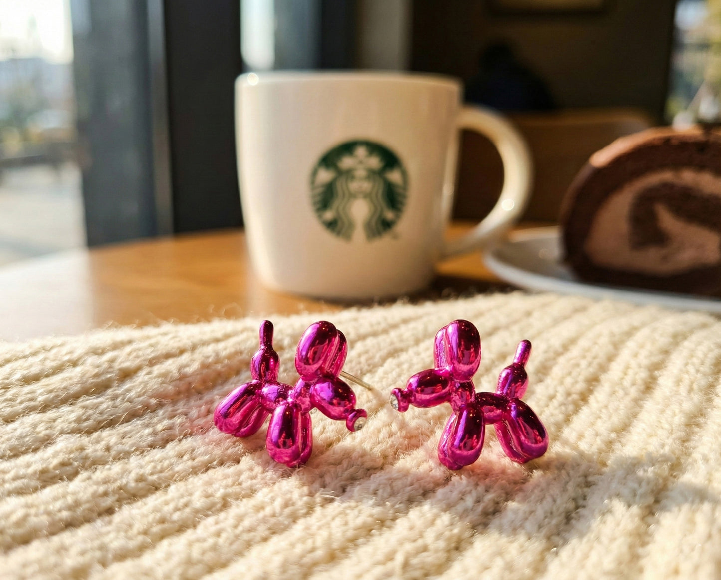 Fuchsia pink balloon dog stud earrings on textured fabric showing vibrant Y2K aesthetic