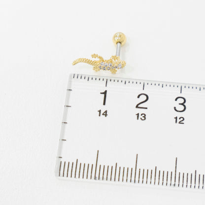 Gold earring on a ruler for size reference
