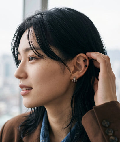 Downtown girl ear piercing inspo, clover tragus stud with hoop mismatch look.