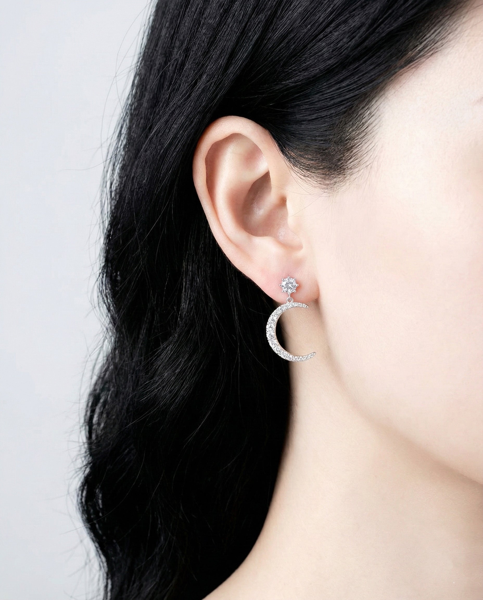 Full view of celestial asymmetric earrings on model
