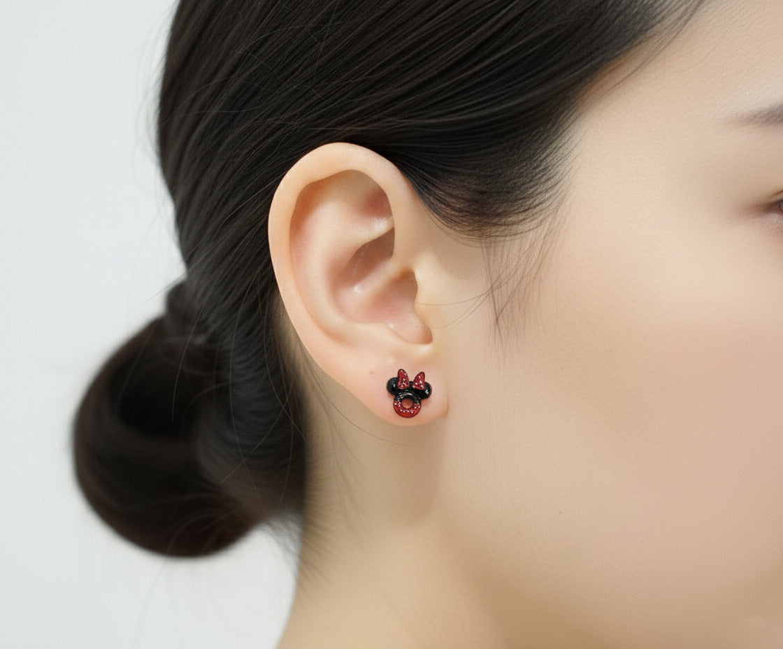 Close up of Minnie Mouse red polka dot bow ladybug stud earring on ear