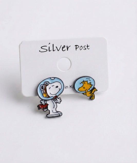 Pair of enamel Snoopy and Woodstock astronaut earrings attached to a white earring card with "Silver Post" text, placed on a white background.