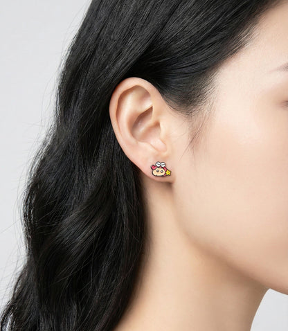 Asian woman wearing Crayon Shin-chan character stud earring with detailed enamel finish, close-up ear shot