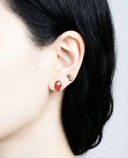 Model wearing Ponyo and rainbow shooting star stud earrings, front view