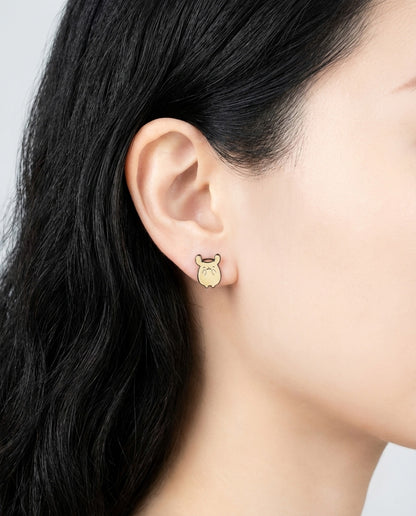 Close-up of asymmetric Pompompurin earrings with different poses