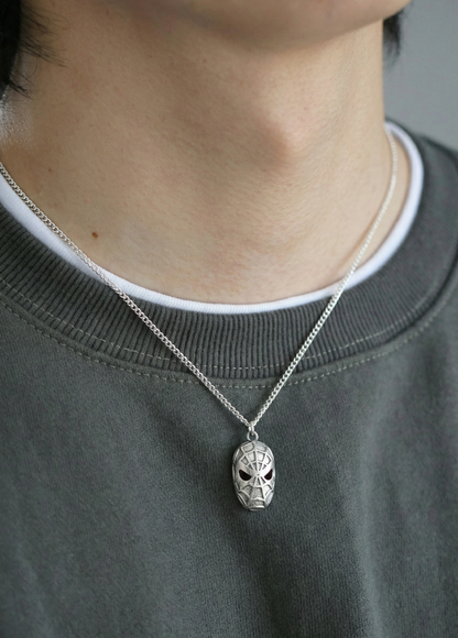 Man demonstrating the 50cm chain length with a silver spider pendant