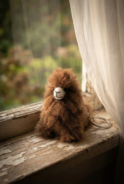  Handmade alpaca plush keyring on vintage white windowsill with natural outdoor light