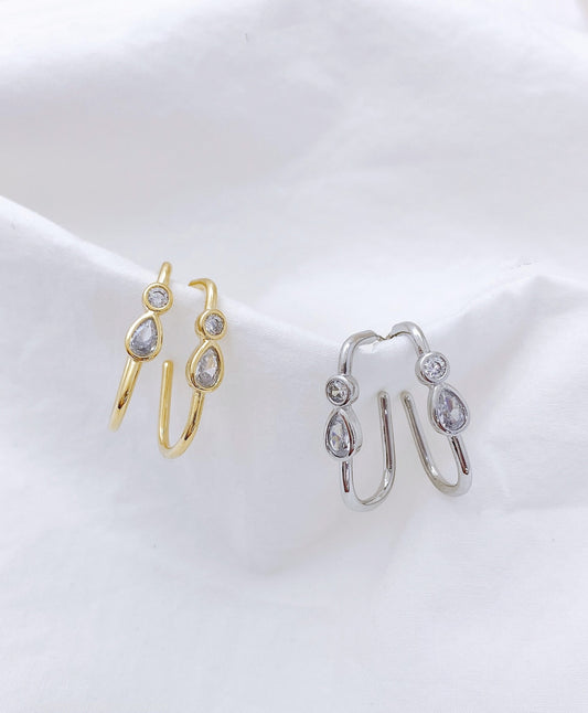 Gold and silver bezel-set U-shaped double cubic zirconia hoop earrings comparison on white background