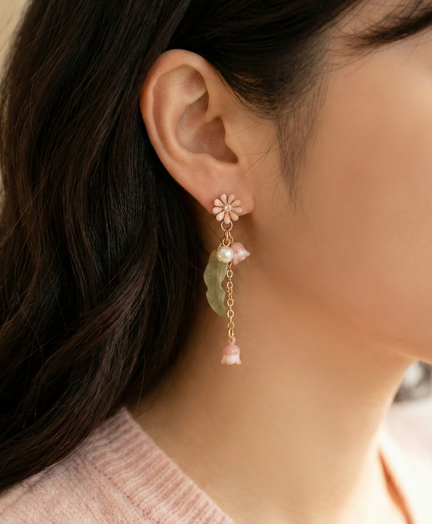  Side view of a woman wearing the romantic pink floral pearl drop earring.
