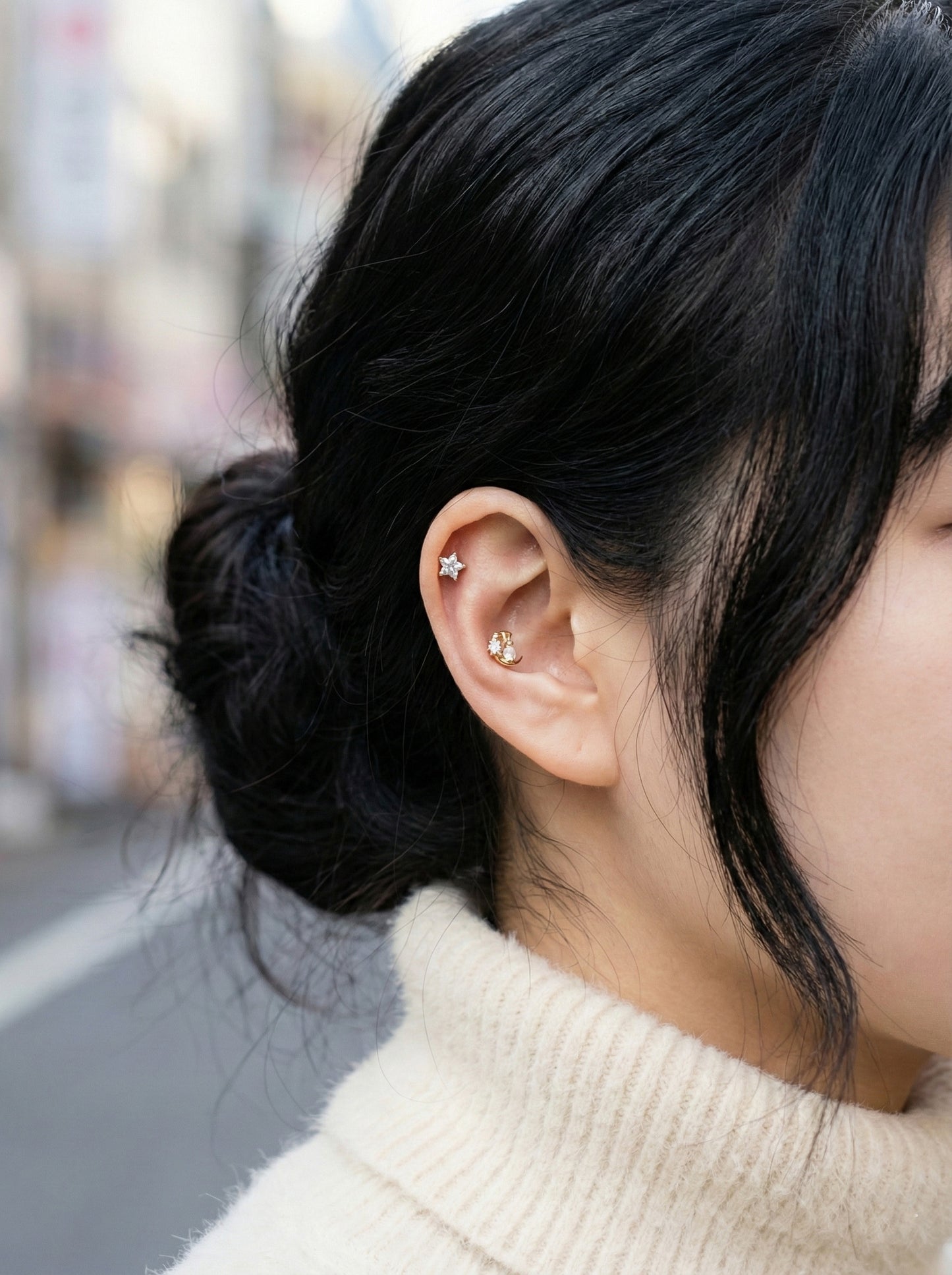 Silver moon bunny earring worn outdoors showing how cubic zirconia catches natural light