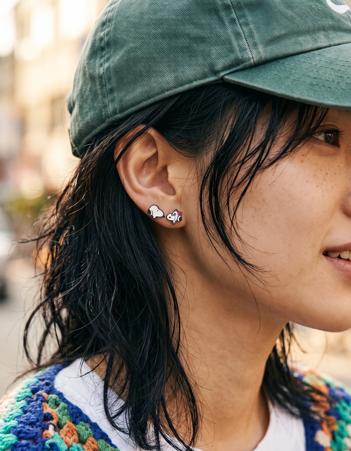 Baseball cap styled with cartoon dog stud earrings, casual K-style ear stack