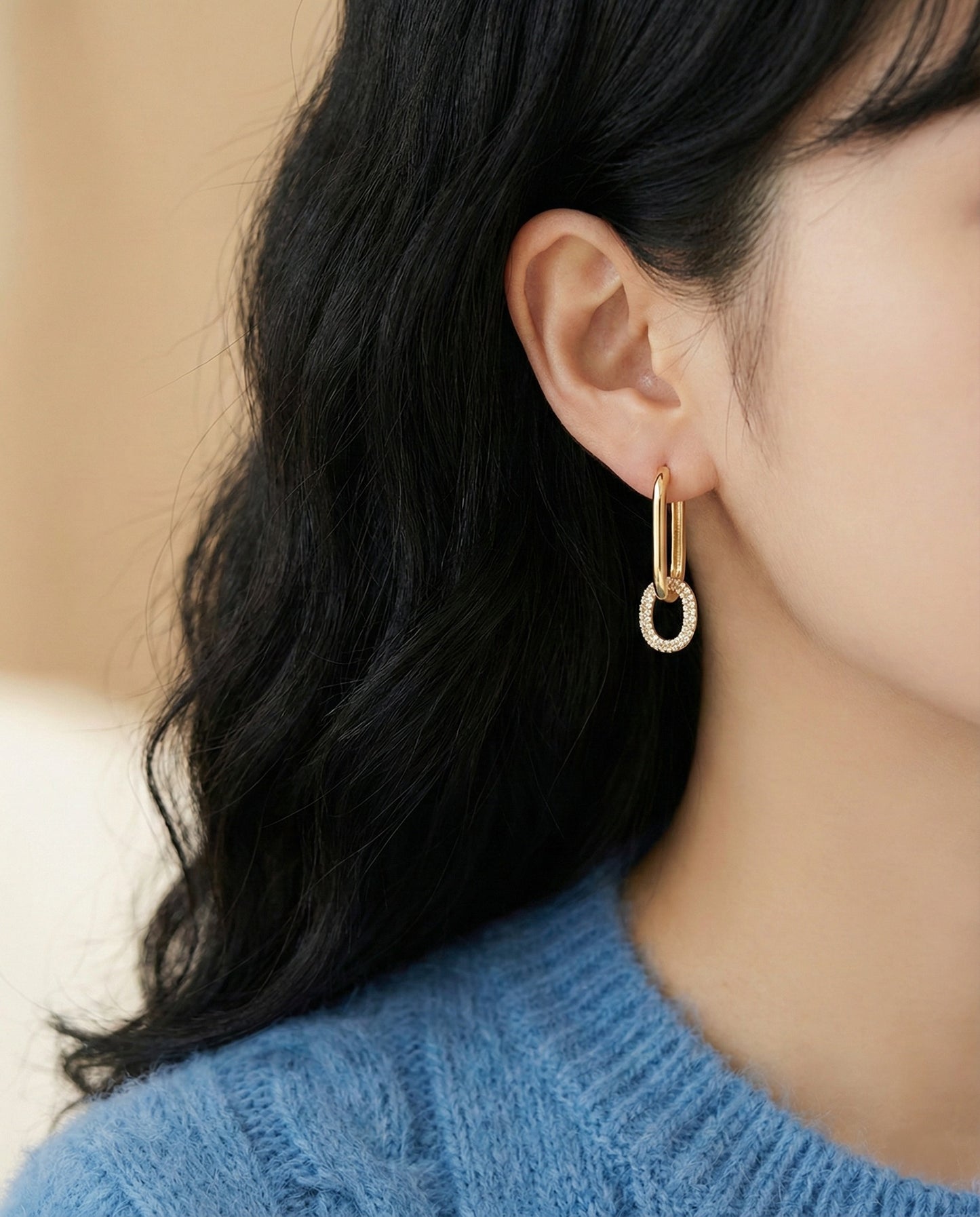 Woman modeling gold oval link drop earrings, bottom pave CZ, casual daily style